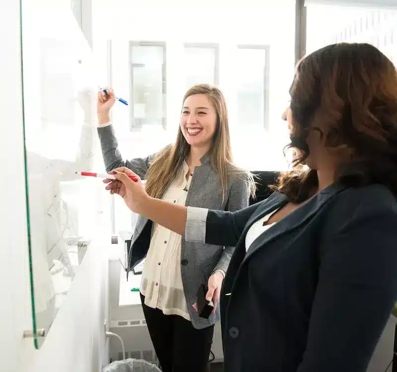Two people at whiteboard